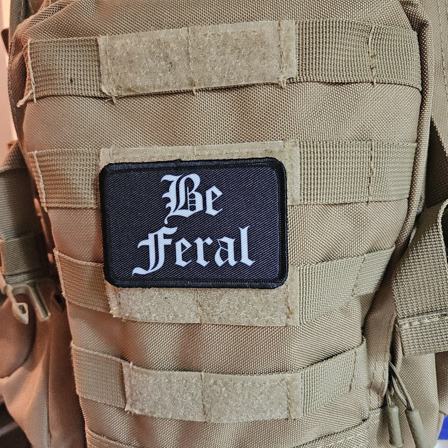 Black and white "be feral" girls and boys meme 2"x3" morale patch with hook and loop backing
