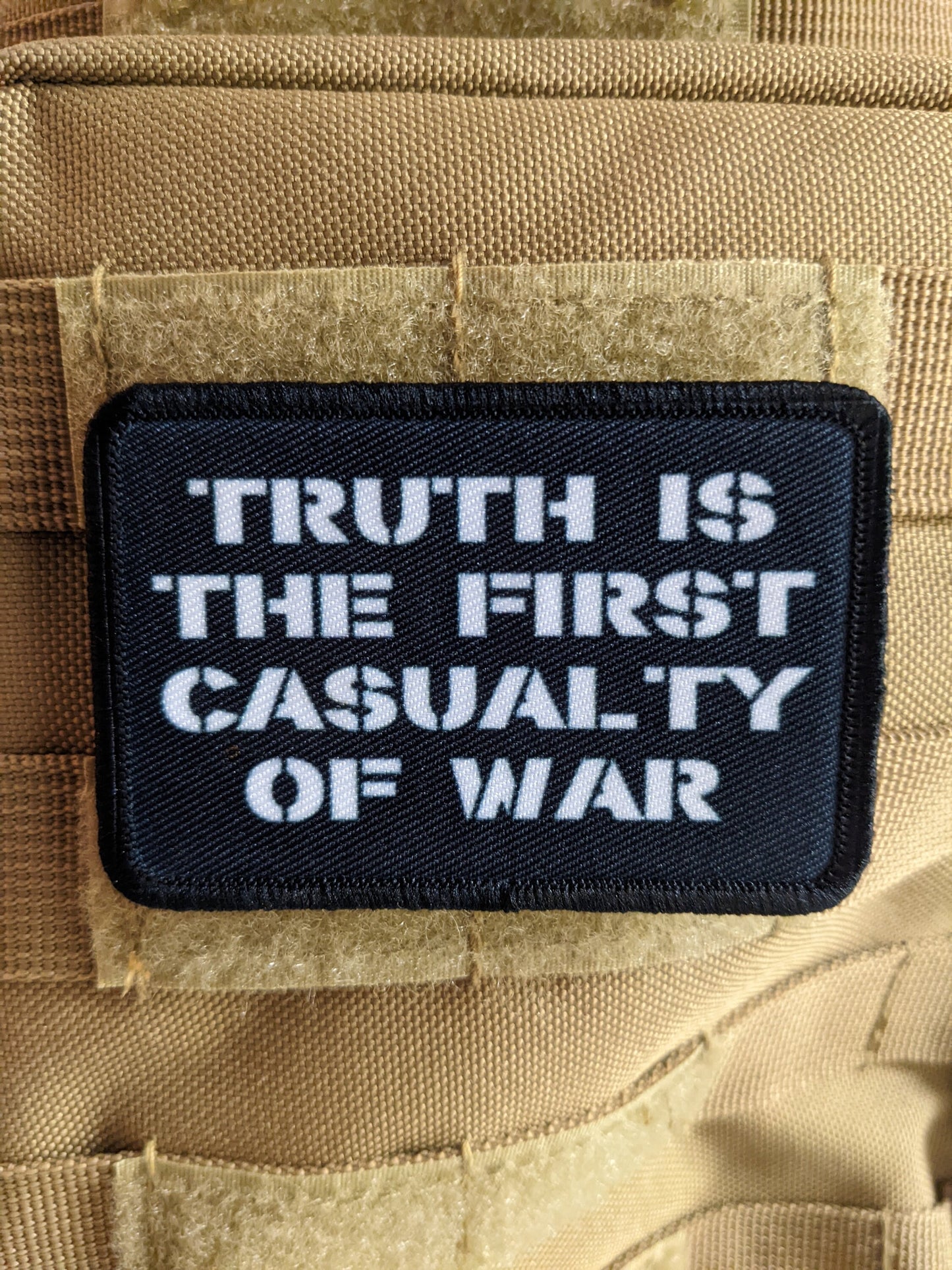 Truth is the first casualty of war 2"x3" morale patch with hook and loop backing