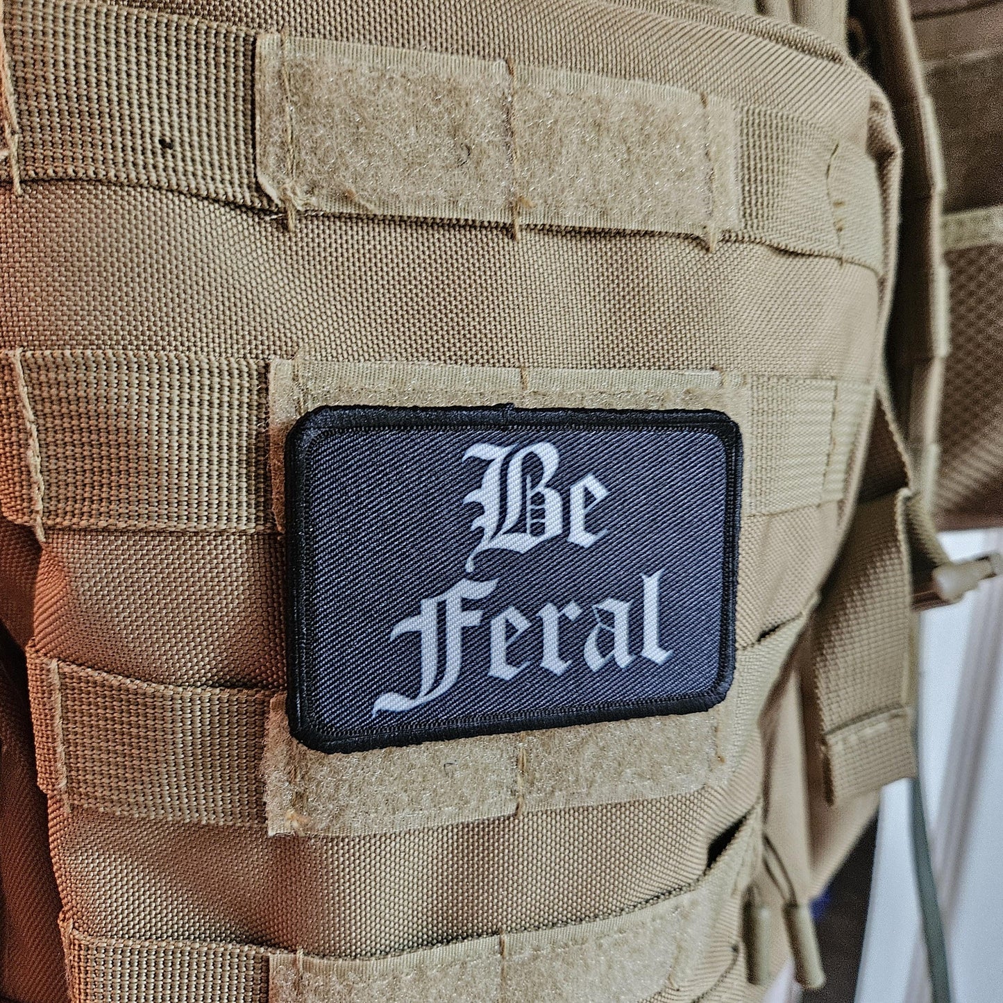 Black and white "be feral" girls and boys meme 2"x3" morale patch with hook and loop backing