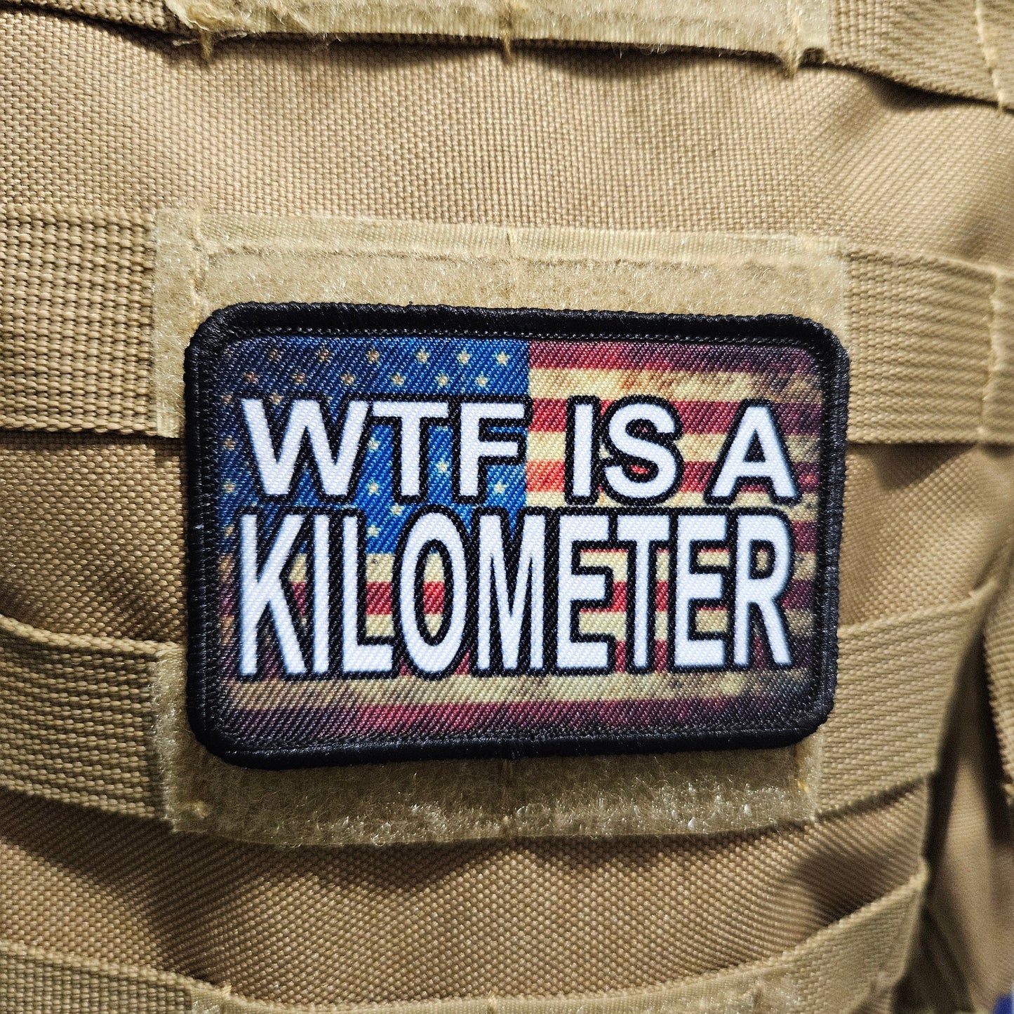 Wtf is a kilometer American flag 2"x3" morale patch with hook and loop backing