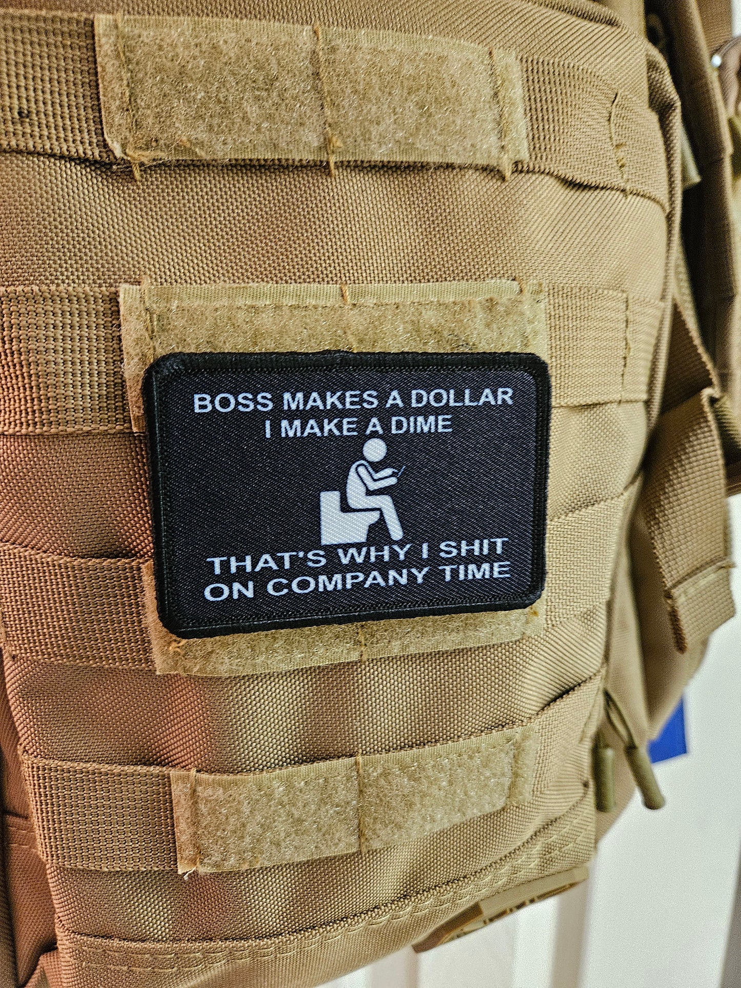 Boss makes a dollar I make a dime that's why I shit on company time 2"x3" morale patch with hook and loop backing black