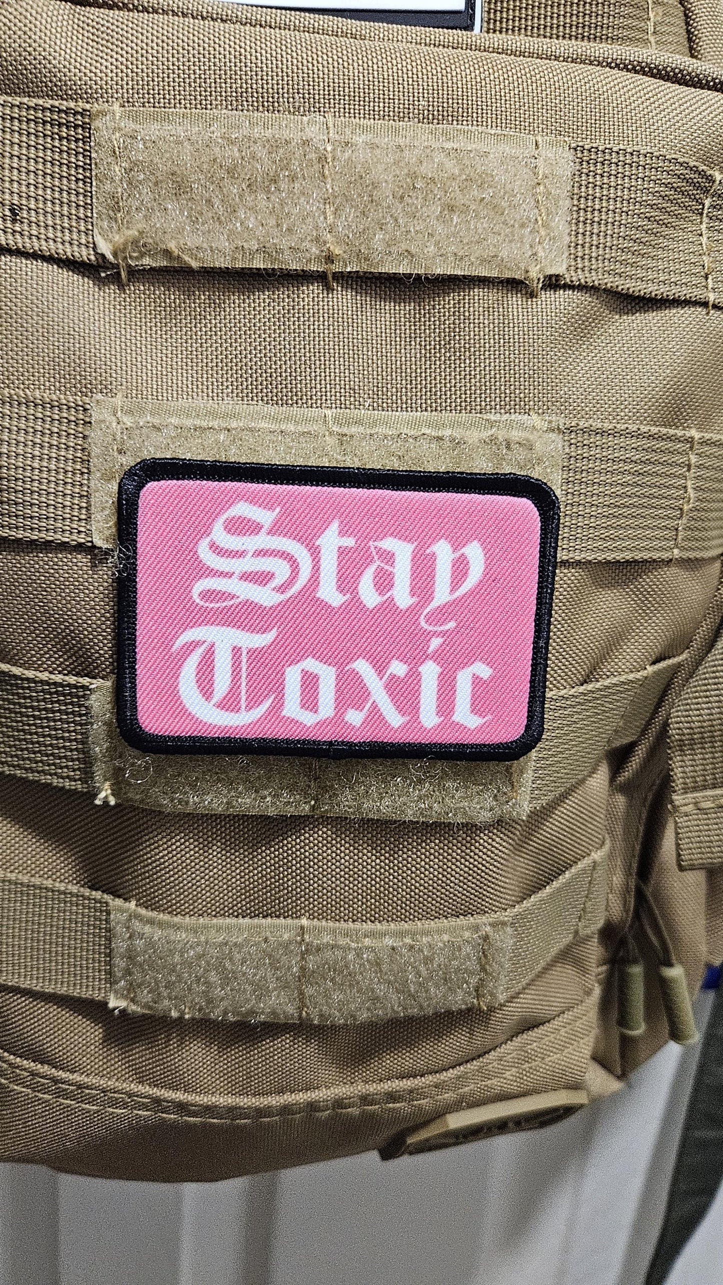 Stay toxic meme pink and white 2"x3" removable morale patch with hook and loop backing