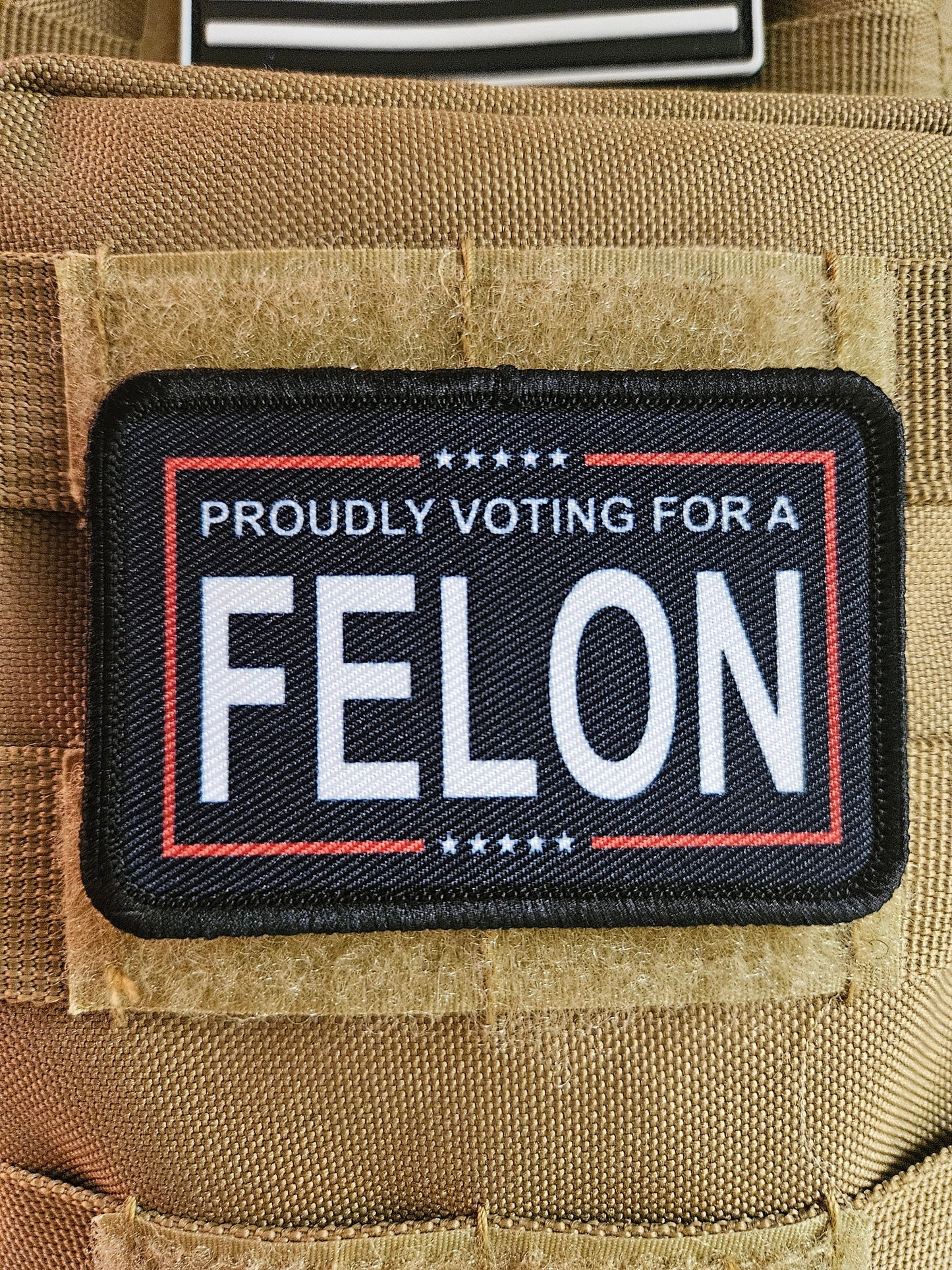 Proudly voting for a felon black 2"x3" removable morale patch with hook and loop backing meme