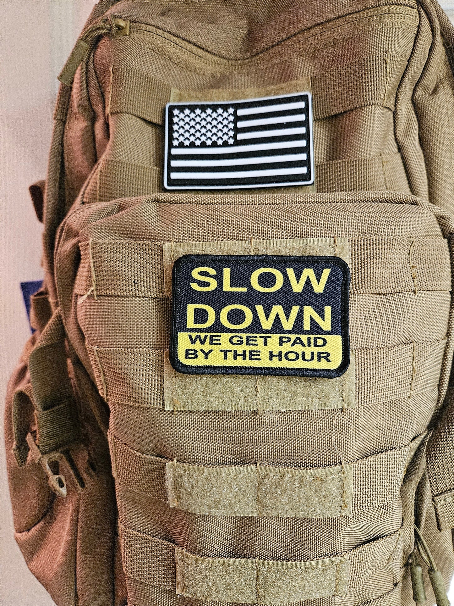 Slow down we get paid by the hour 2"x3" morale patch with hook and loop backing blue collar