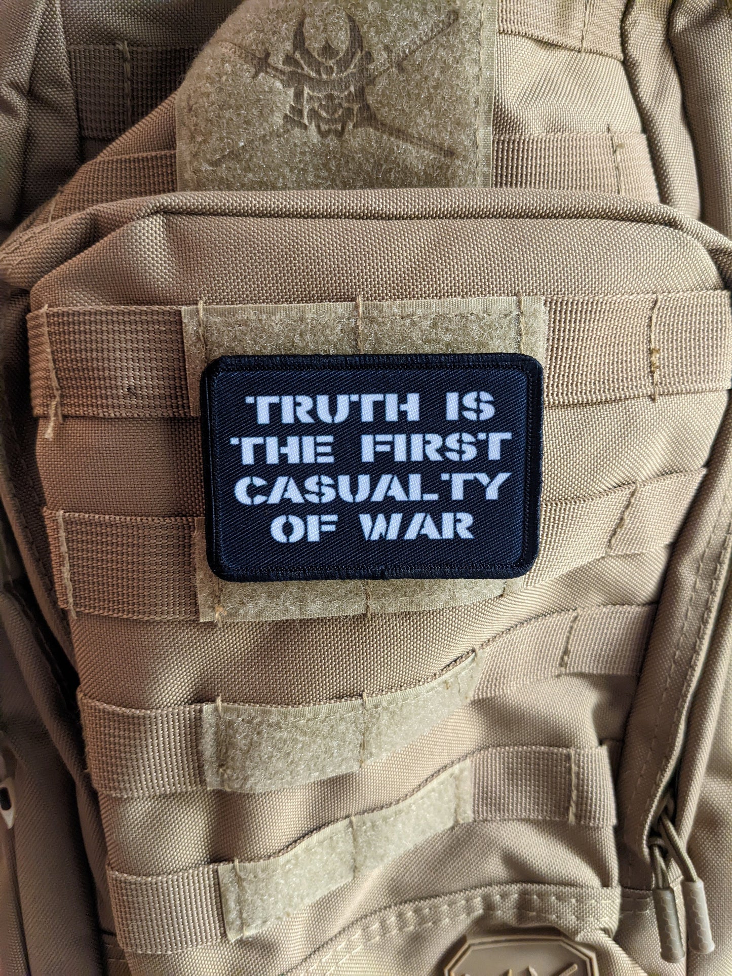 Truth is the first casualty of war 2"x3" morale patch with hook and loop backing