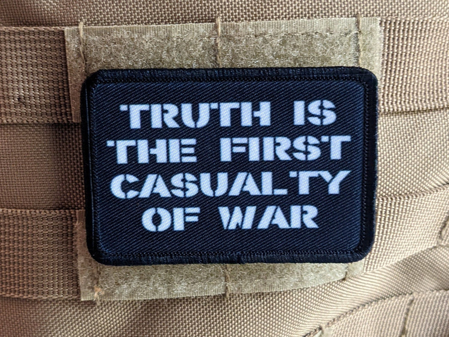 Truth is the first casualty of war 2"x3" morale patch with hook and loop backing