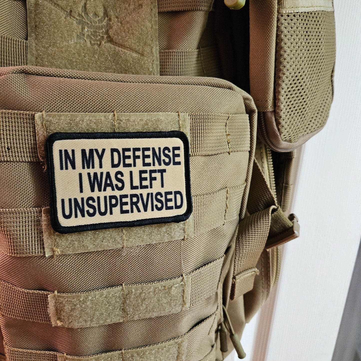 Tan In My Defense I was left Unsupervised removable patch 2"x3" morale patch with hook and loop backing