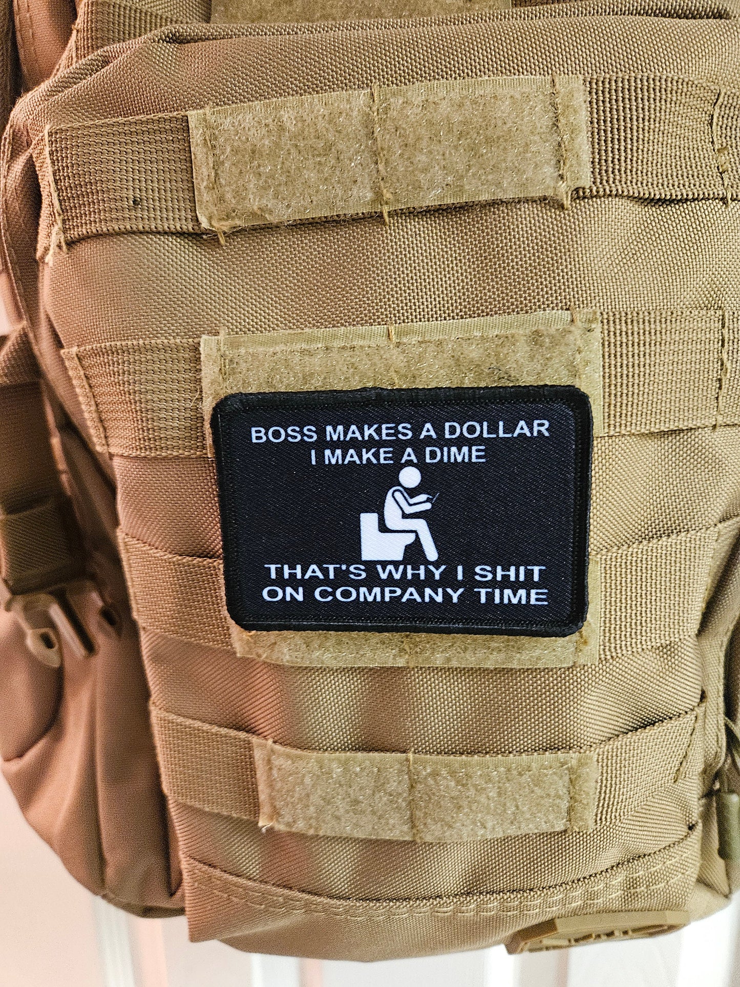 Boss makes a dollar I make a dime that's why I shit on company time 2"x3" morale patch with hook and loop backing black