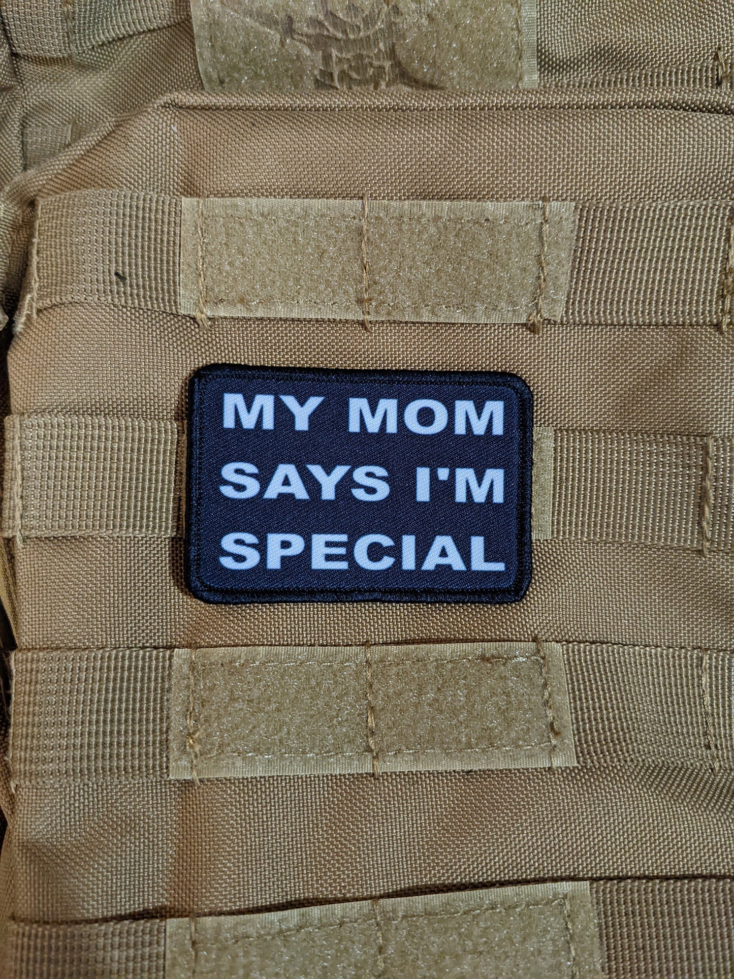 my mom says i'm special funny 2"x3" morale patch with hook and loop backing green background