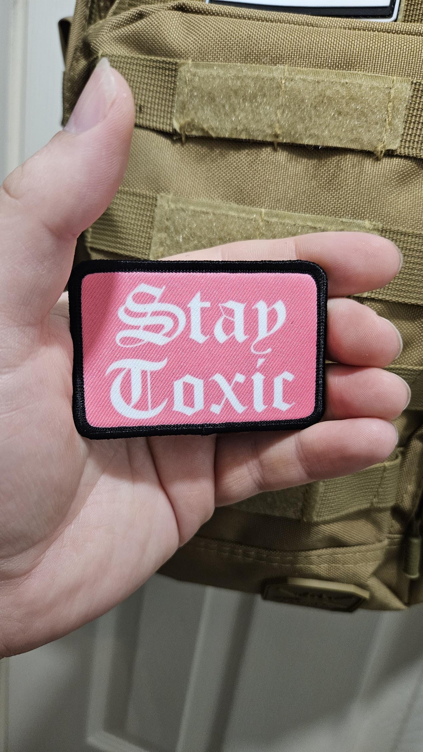 Stay toxic meme pink and white 2"x3" removable morale patch with hook and loop backing