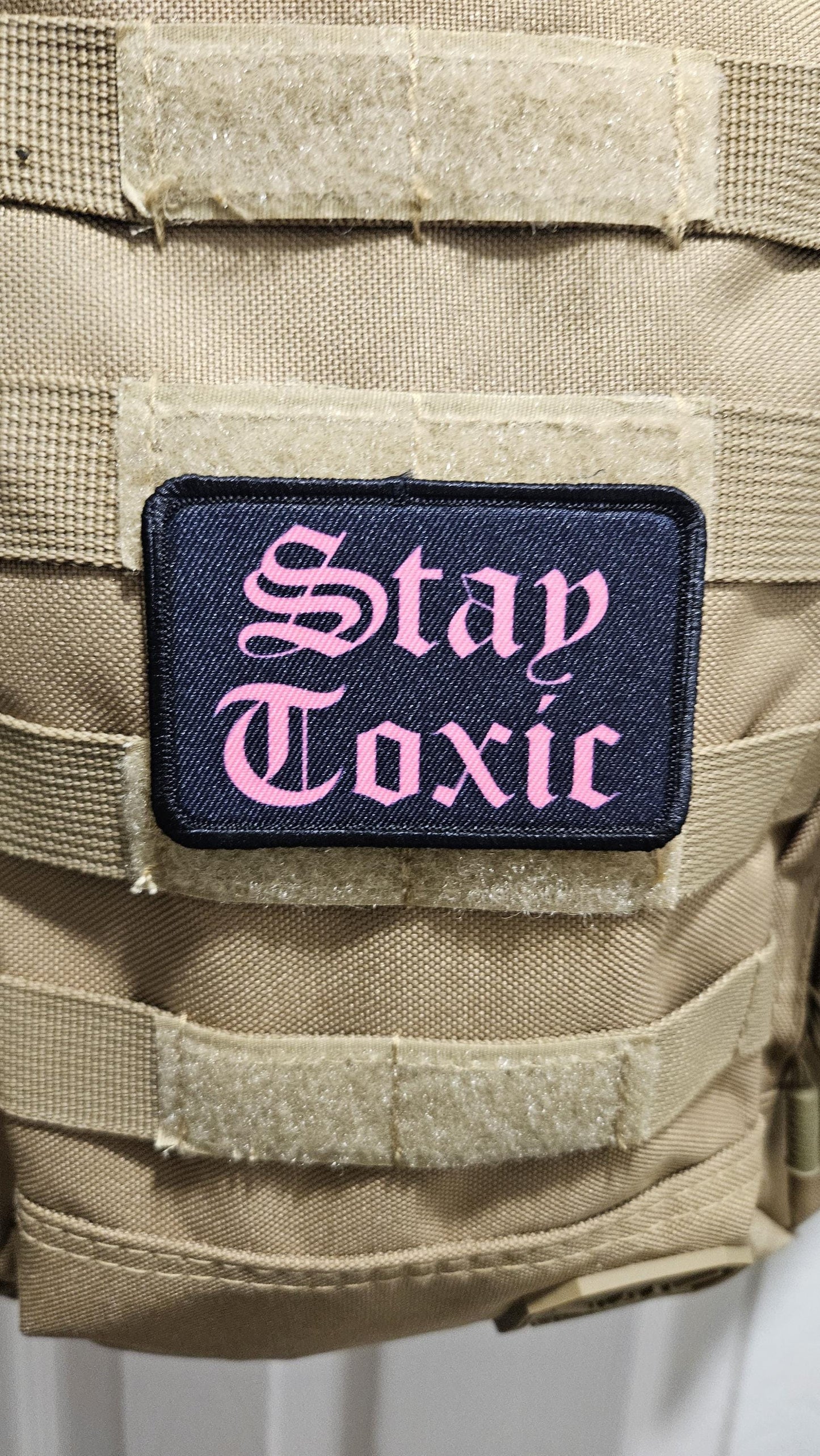 Stay toxic meme pink on black 2"x3" removable morale patch with hook and loop backing