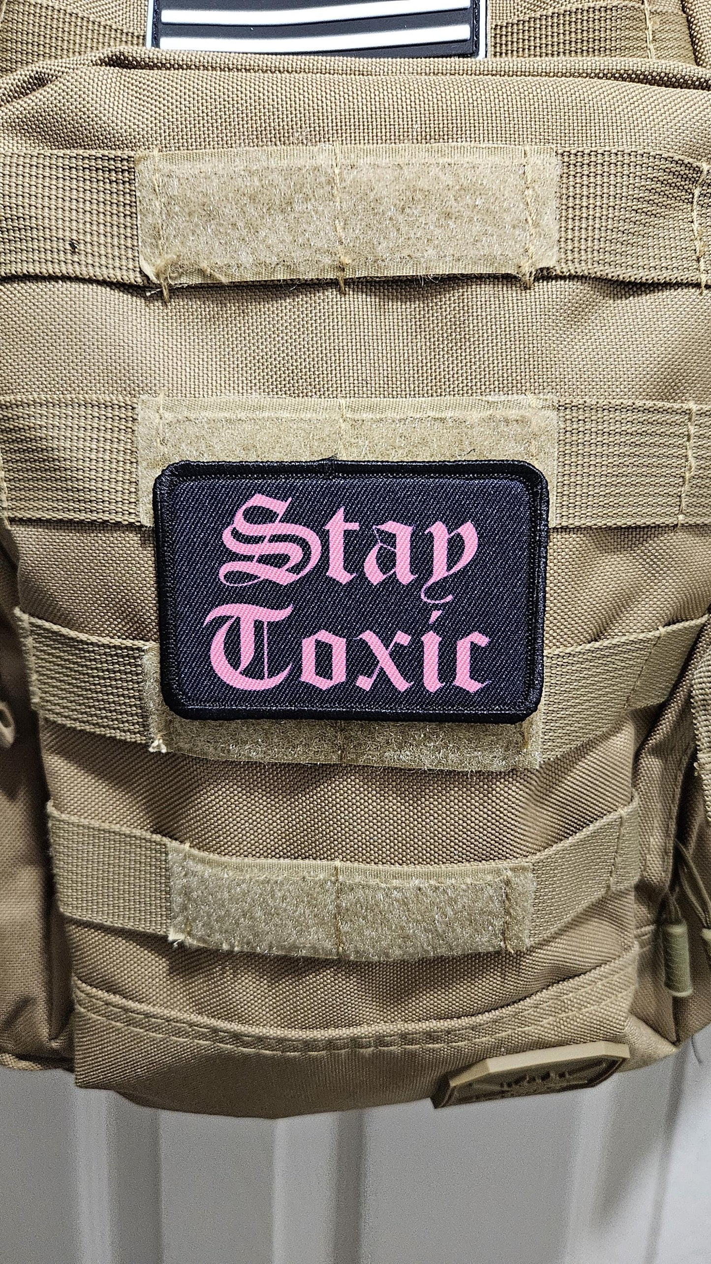 Stay toxic meme pink on black 2"x3" removable morale patch with hook and loop backing