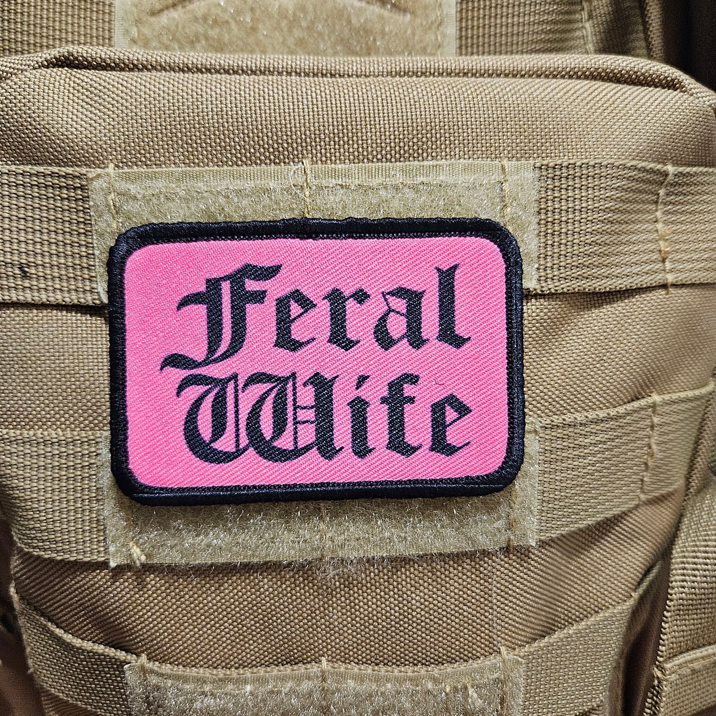 Feral wife meme 2"x3" morale patch with hook and loop backing black on pink