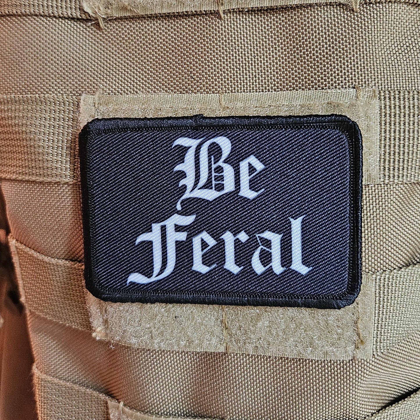Black and white "be feral" girls and boys meme 2"x3" morale patch with hook and loop backing