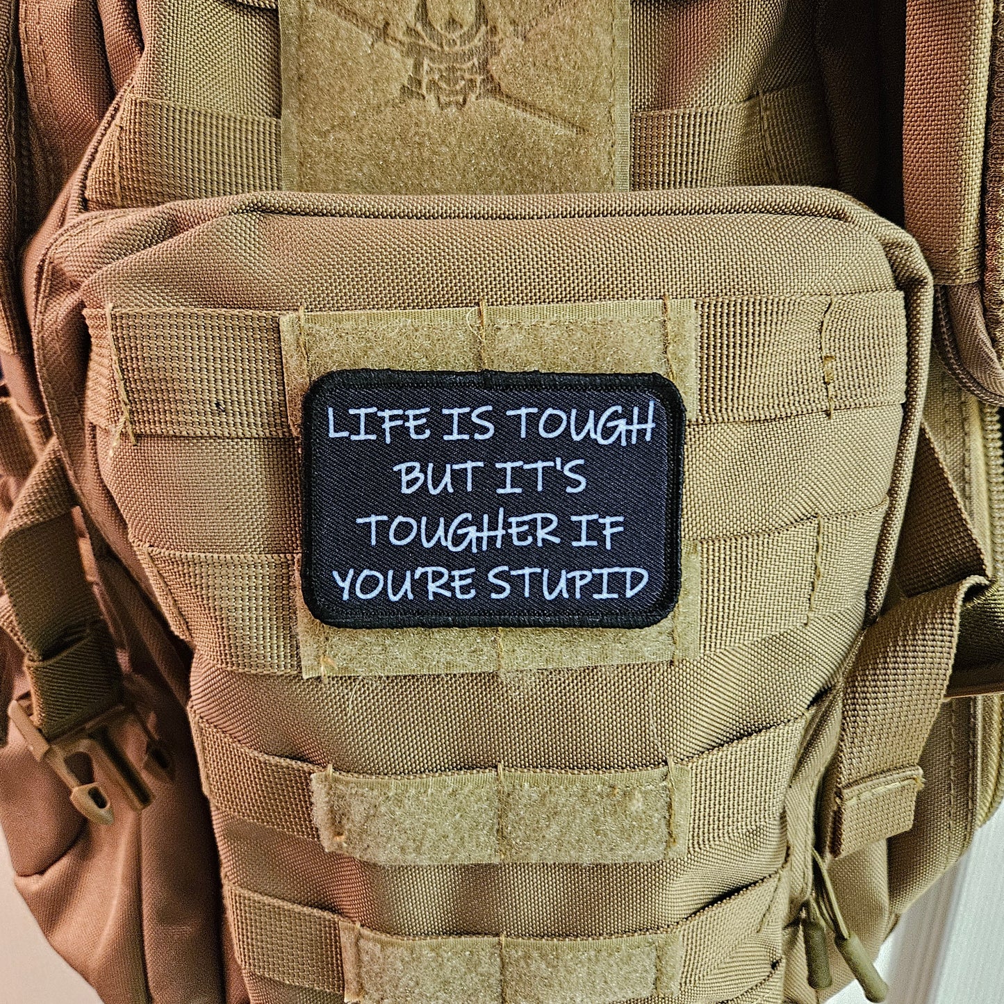 Life is tough but it's tougher if you're stupid meme 2"x3" removable morale patch with hook and loop backing black and white