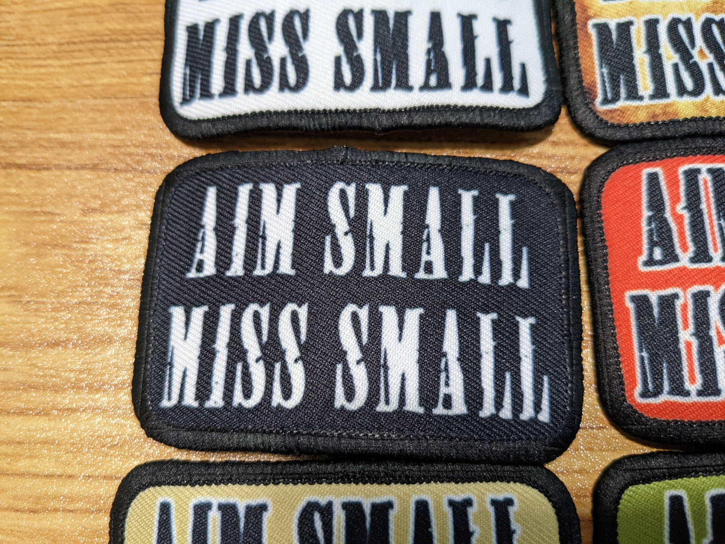 Aim Small Miss Small Patriot quote 2"x3" removable morale patch with hook and loop backing