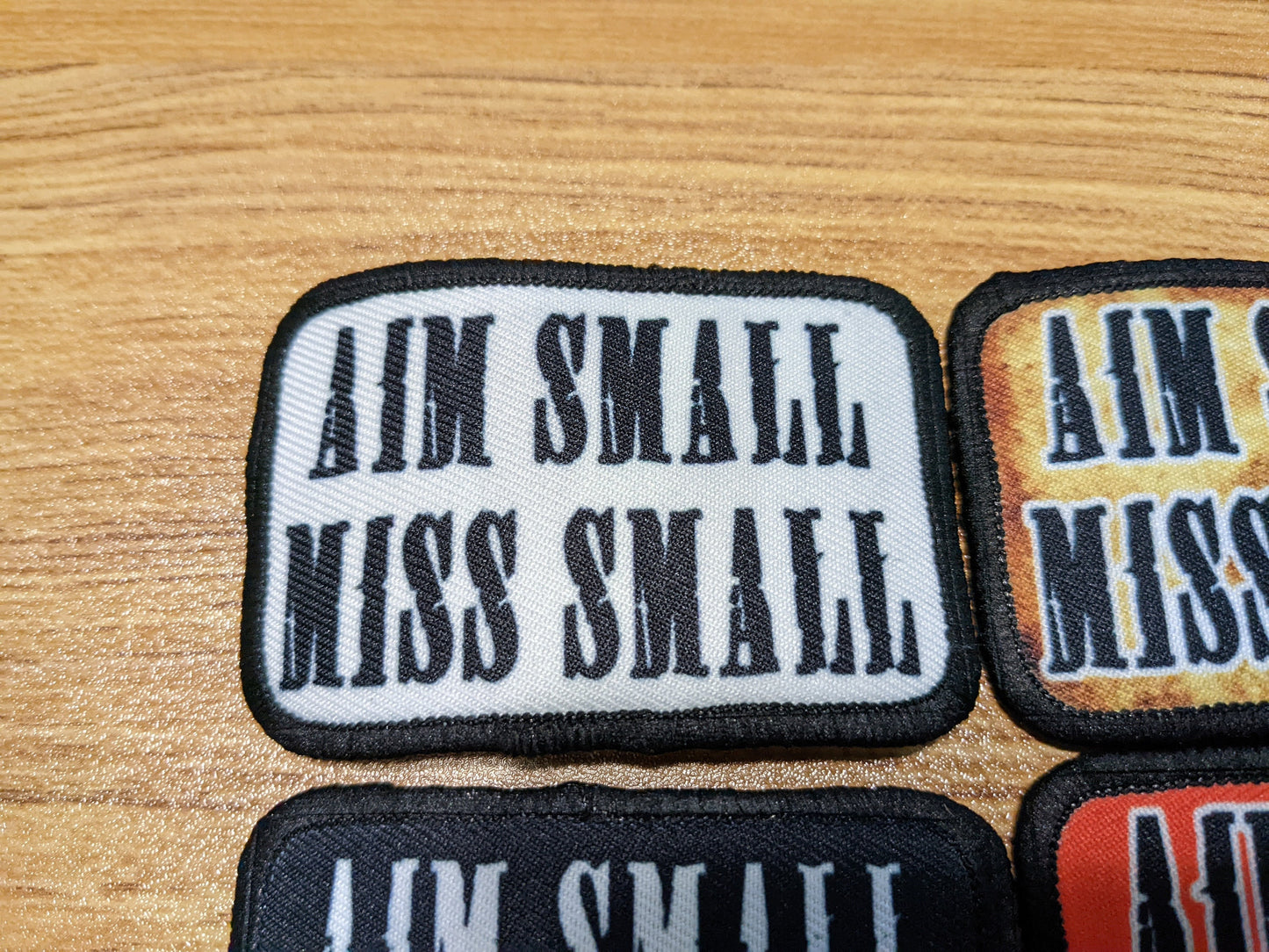 Aim Small Miss Small Patriot quote 2"x3" removable morale patch with hook and loop backing