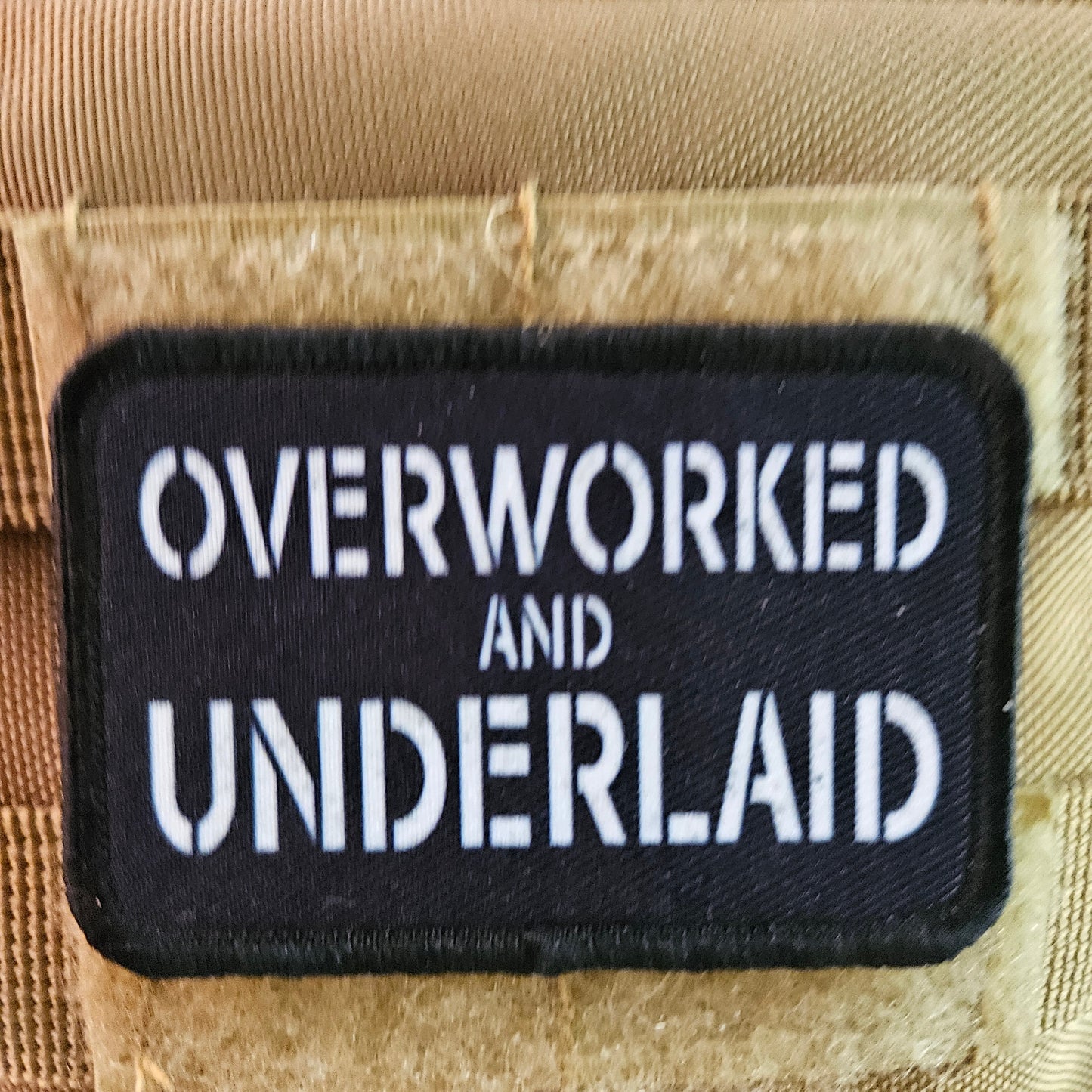 Overworked and underlaid 2"x3" removable morale patch with hook and loop backing black and white