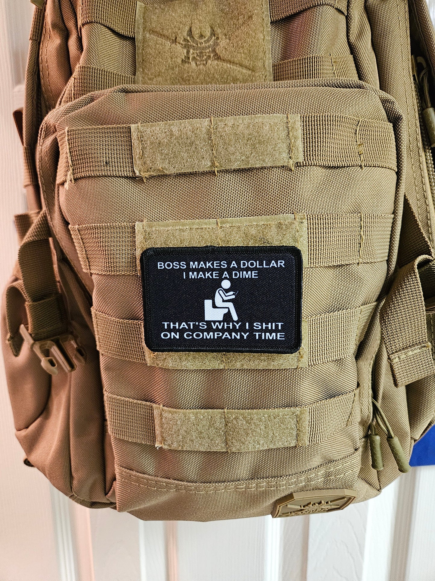 Boss makes a dollar I make a dime that's why I shit on company time 2"x3" morale patch with hook and loop backing black