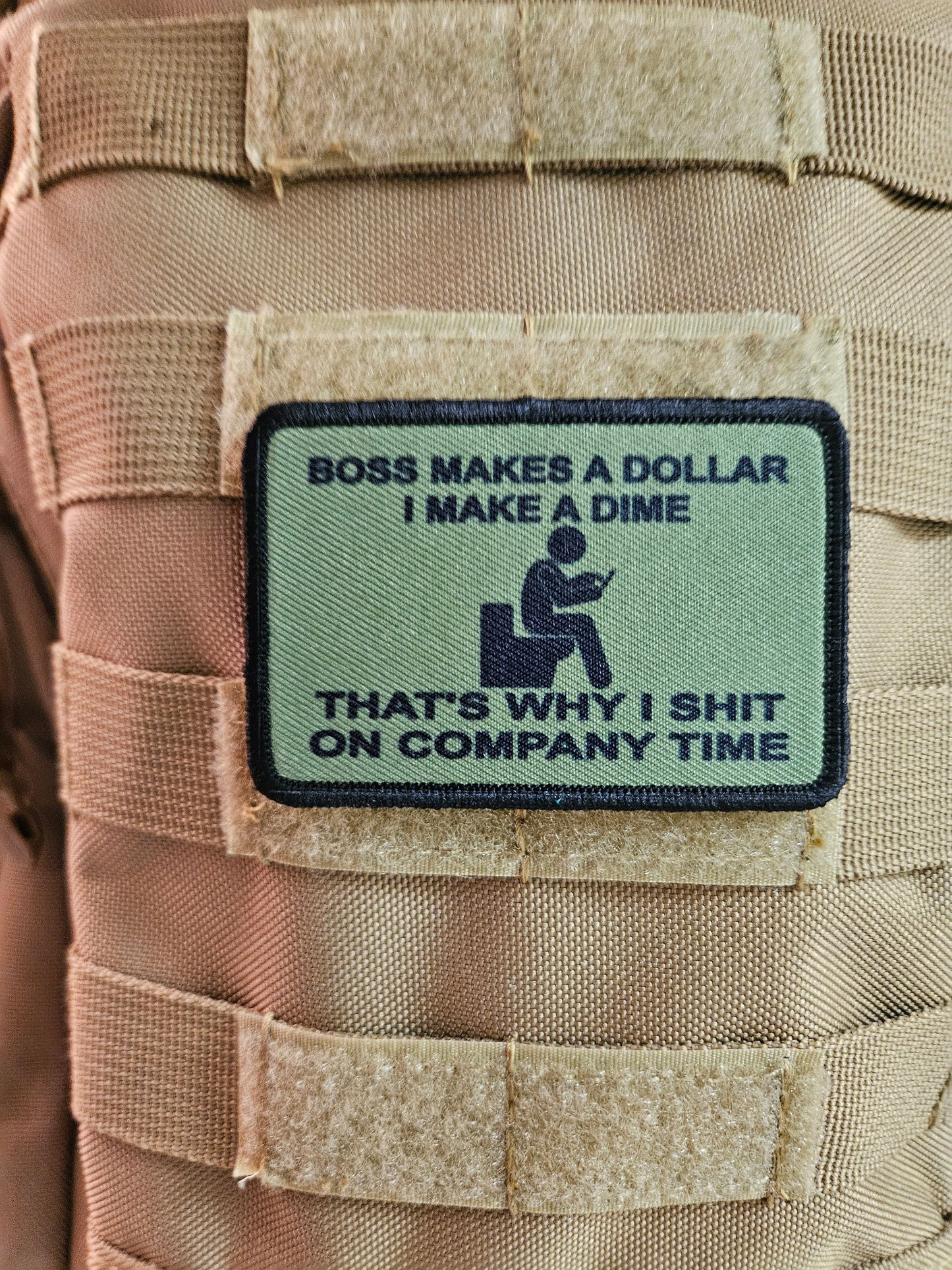Boss makes a dollar I make a dime that's why I shit on company time 2"x3" morale patch with hook and loop backing green