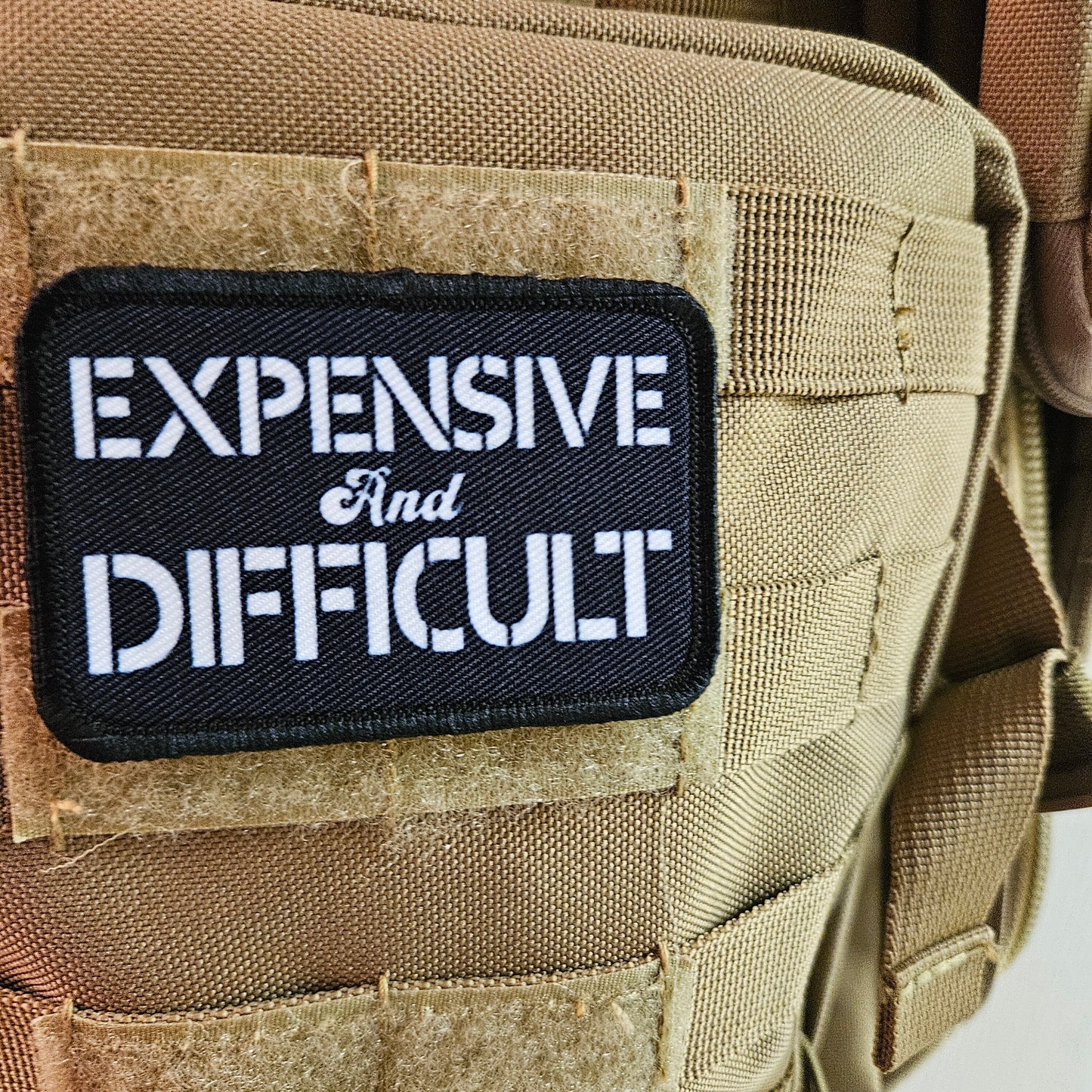 Expensive  and difficult meme black 2"x3" removable morale patch with hook and loop backing