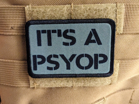 It's a Psyop conspiracy joke gray 2"x3" morale patch with hook and loop backing