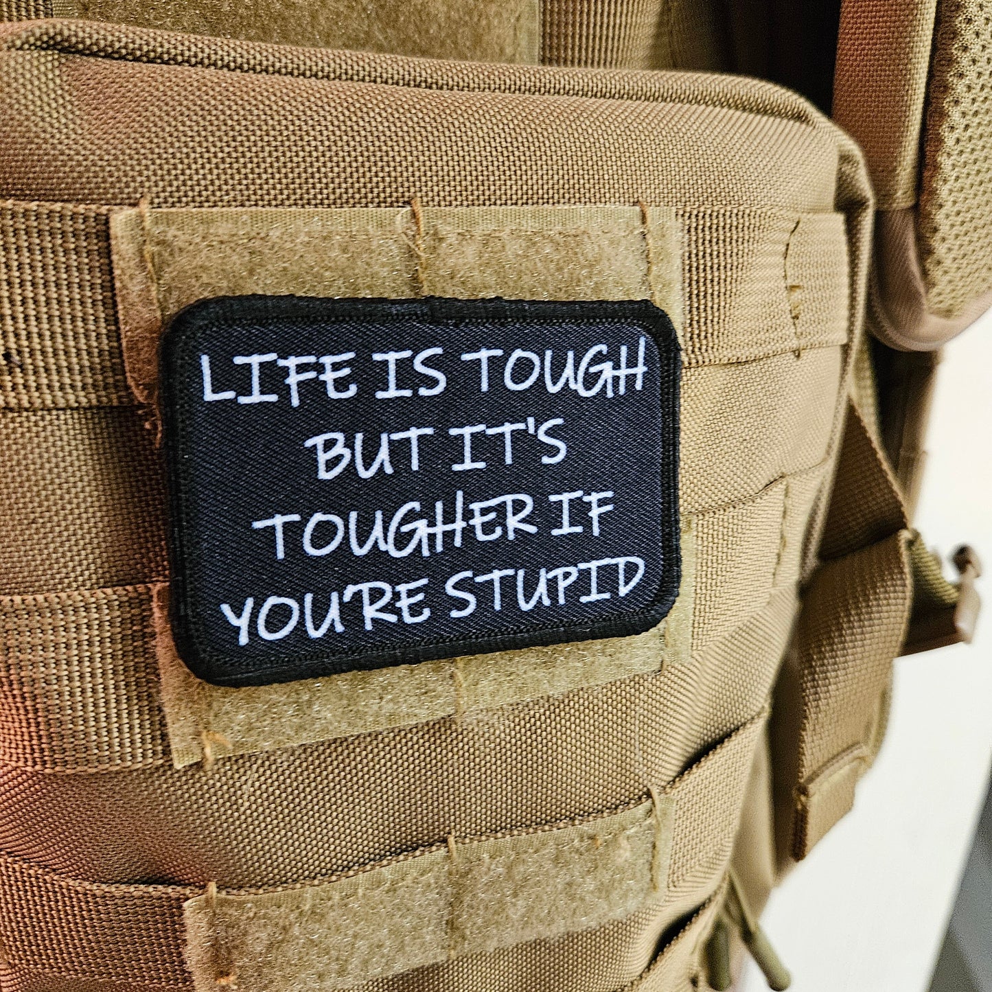 Life is tough but it's tougher if you're stupid meme 2"x3" removable morale patch with hook and loop backing black and white