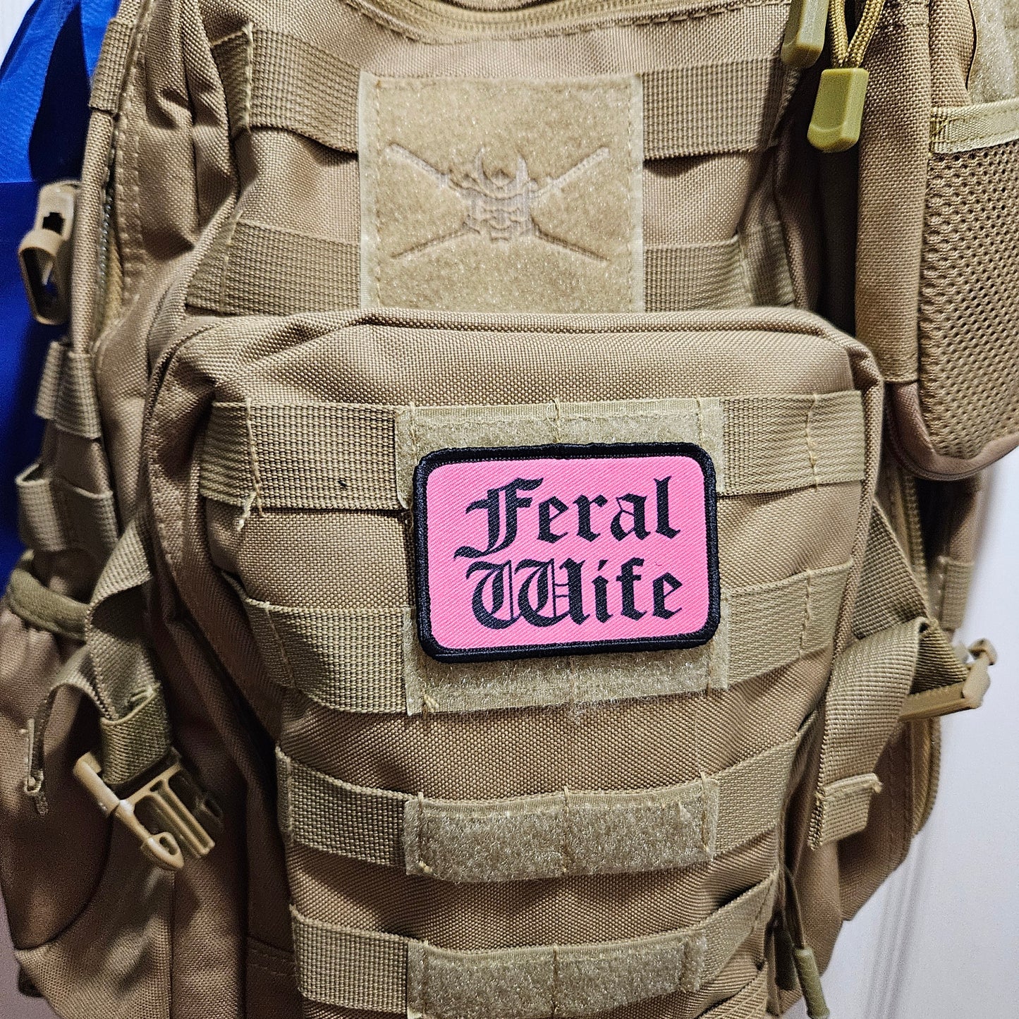 Feral wife meme 2"x3" morale patch with hook and loop backing black on pink