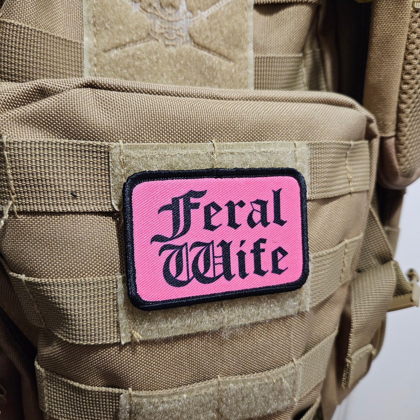 Feral wife meme 2"x3" morale patch with hook and loop backing black on pink