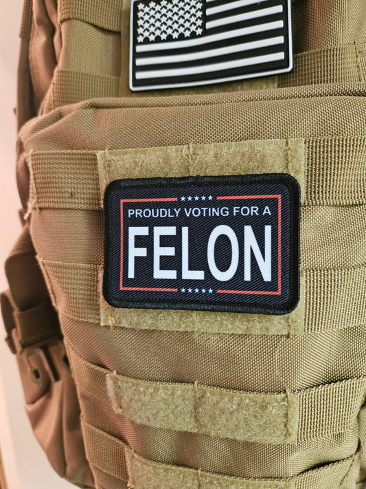 Proudly voting for a felon black 2"x3" removable morale patch with hook and loop backing meme