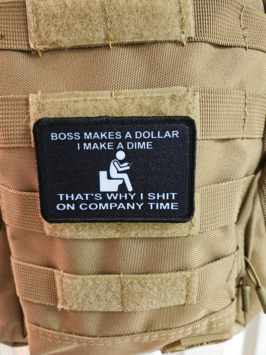 Boss makes a dollar I make a dime that's why I shit on company time 2"x3" morale patch with hook and loop backing black